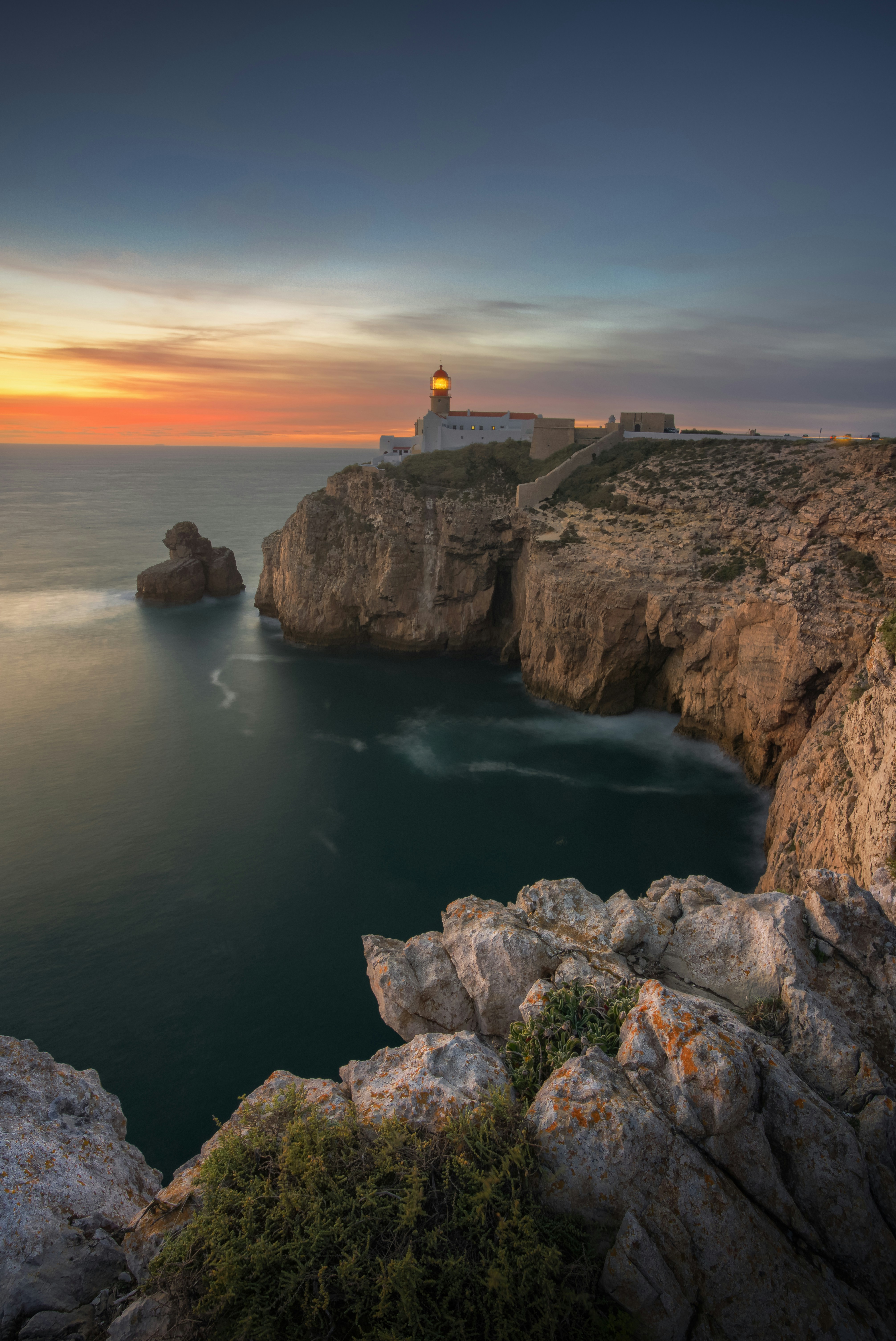 Lighthouse on a rocky cliff by the ocean